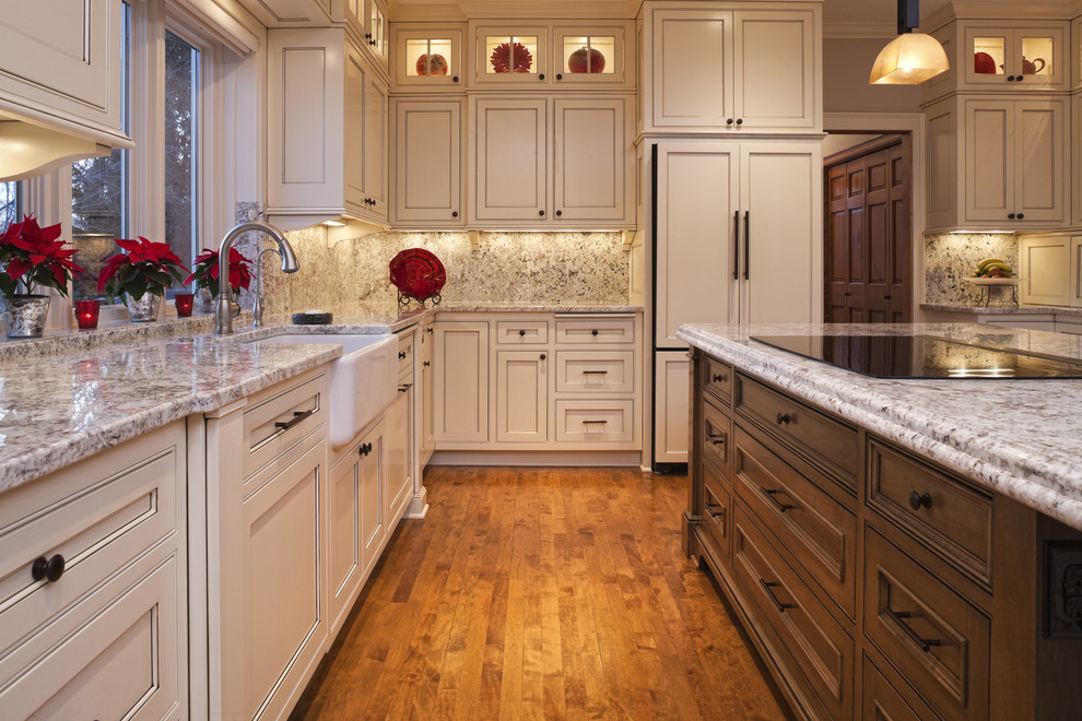 Design ideas for a traditional kitchen in Minneapolis with beaded inset cabinets, a farmhouse sink and panelled appliances.
