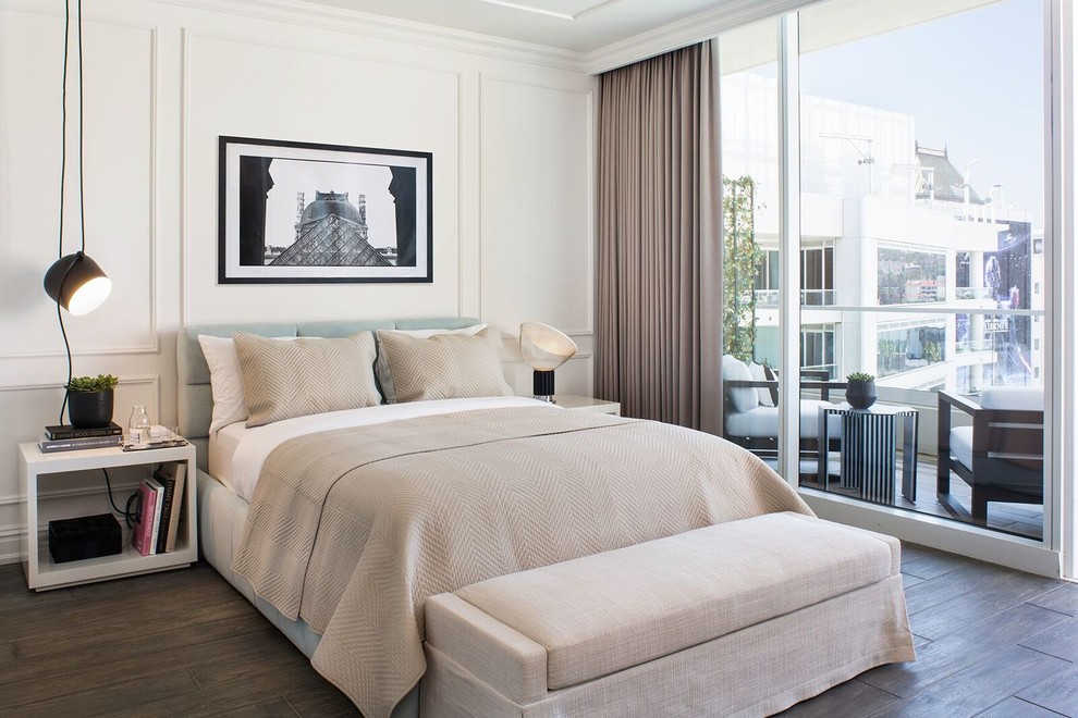 Transitional bedroom in Los Angeles with white walls and brown floor.