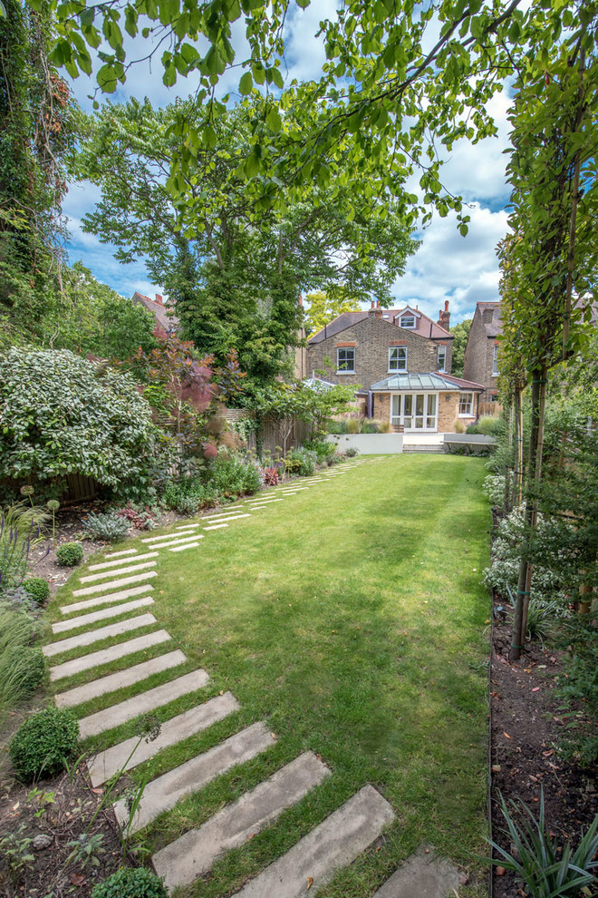 Design ideas for a large traditional backyard partial sun garden in London with a garden path.