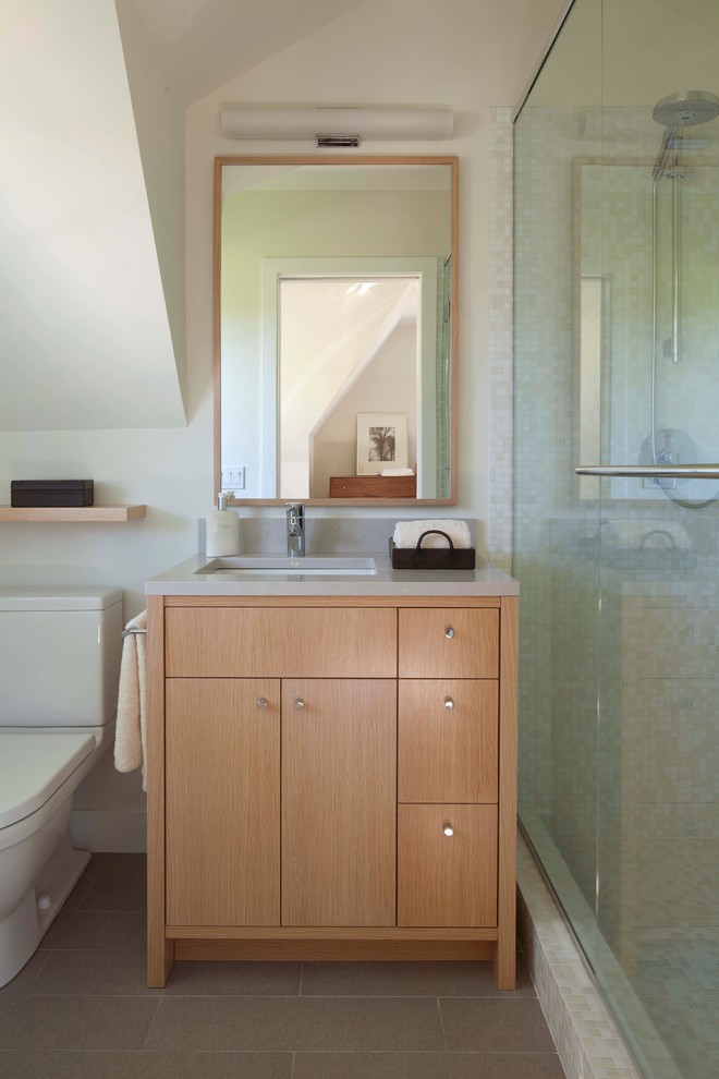 Inspiration for a contemporary bathroom in Minneapolis with an undermount sink, flat-panel cabinets, medium wood cabinets, an alcove shower, a two-piece toilet, white tile, mosaic tile and grey benchtops.