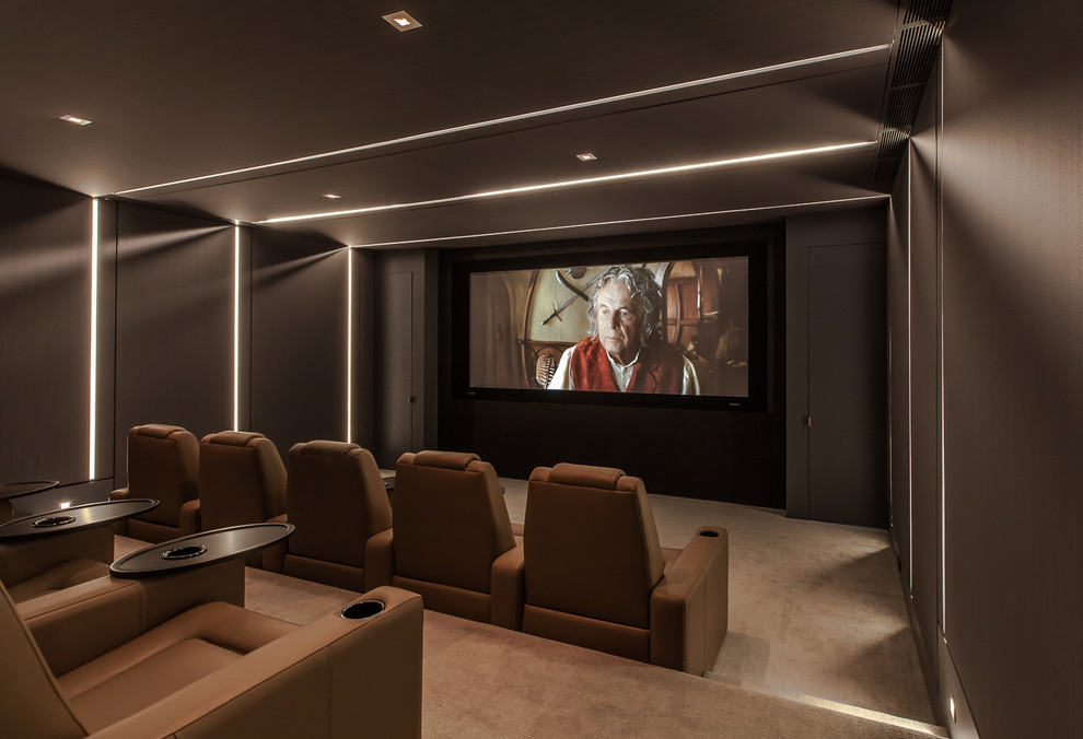 Photo of a mid-sized contemporary enclosed home theatre in Austin with brown walls, carpet, a projector screen and brown floor.