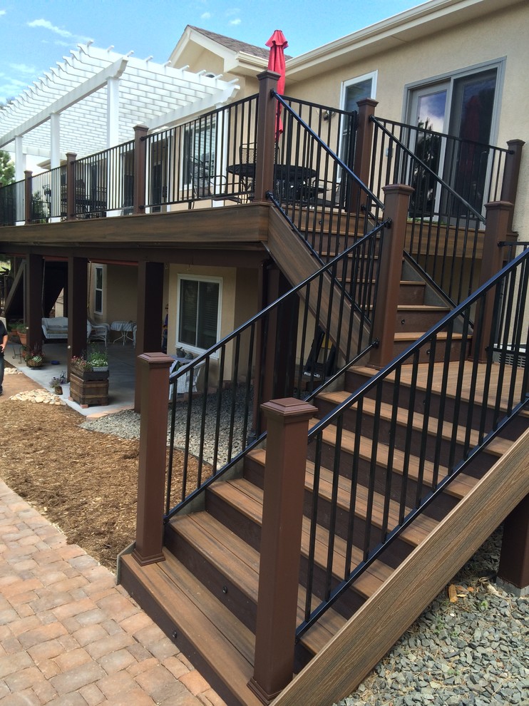 This is an example of a mid-sized transitional backyard deck in San Diego with metal railing and a pergola.