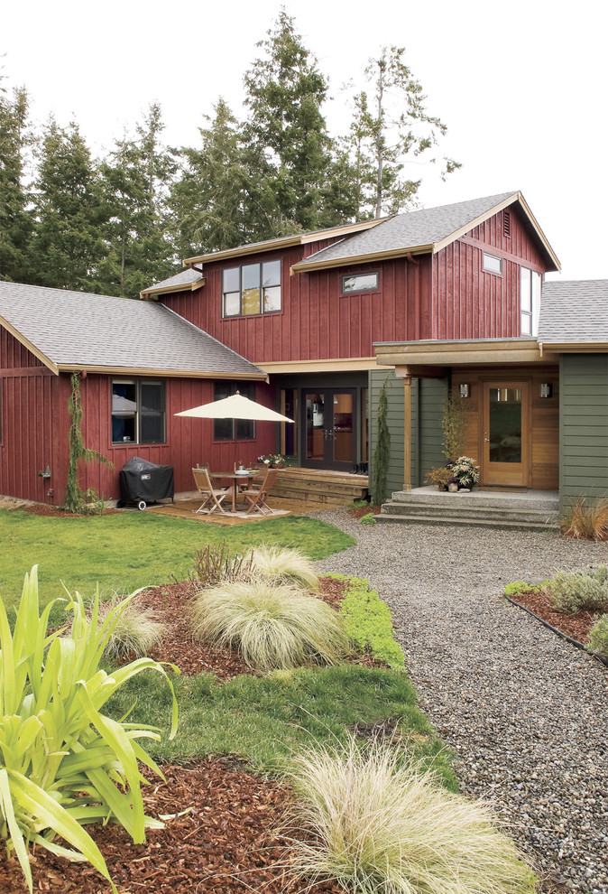 Photo of a country two-storey exterior in Seattle with wood siding.