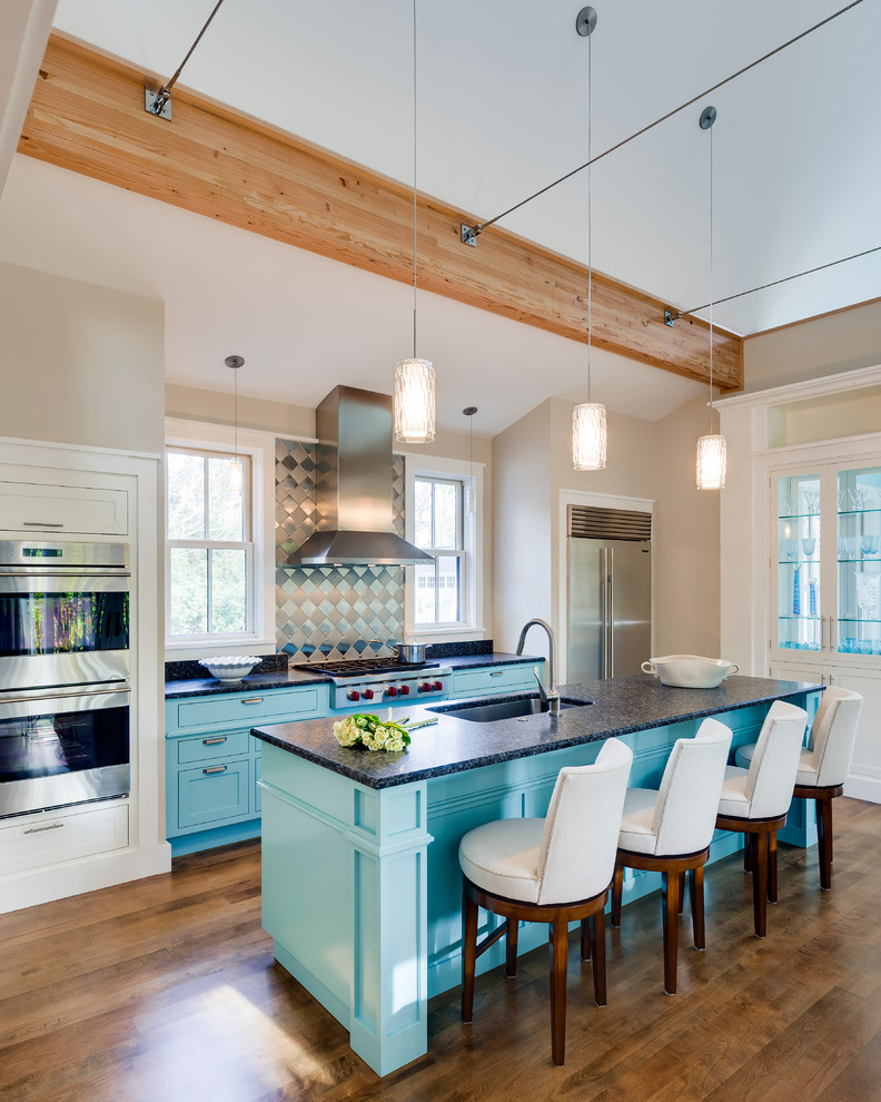 Design ideas for a mid-sized contemporary galley open plan kitchen in Portland Maine with with island, shaker cabinets, metallic splashback, stainless steel appliances, an undermount sink, turquoise cabinets, laminate benchtops, metal splashback and dark hardwood floors.