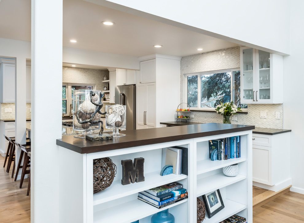 Example of a large transitional light wood floor eat-in kitchen design in Denver with a single-bowl sink, shaker cabinets, white cabinets, quartz countertops, white backsplash, marble backsplash, stainless steel appliances, two islands and gray countertops