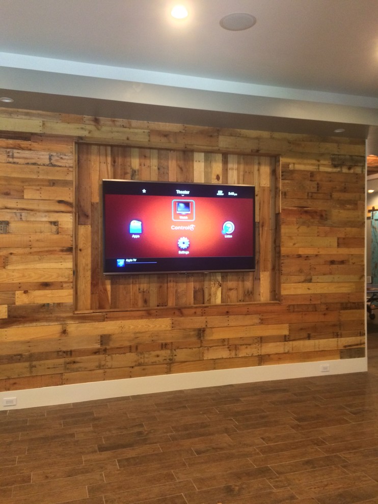 Photo of a mid-sized country open concept home theatre in Detroit with grey walls, ceramic floors and a wall-mounted tv.