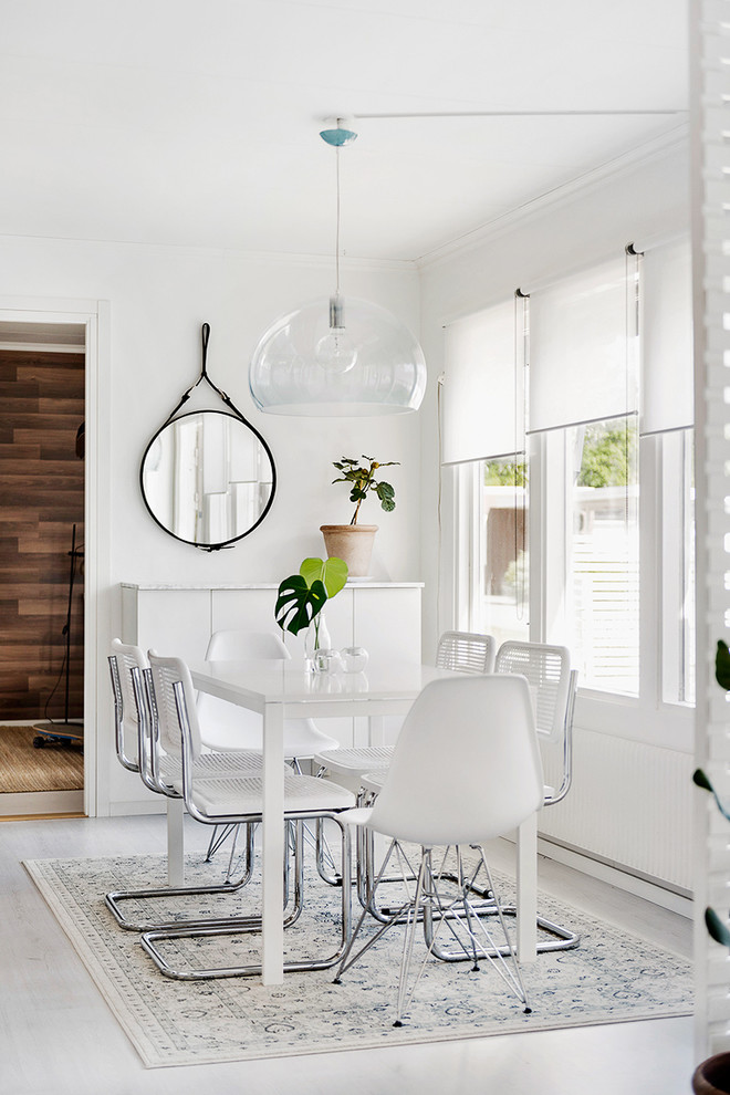 This is an example of a mid-sized contemporary separate dining room in Orebro with white walls, painted wood floors and no fireplace.