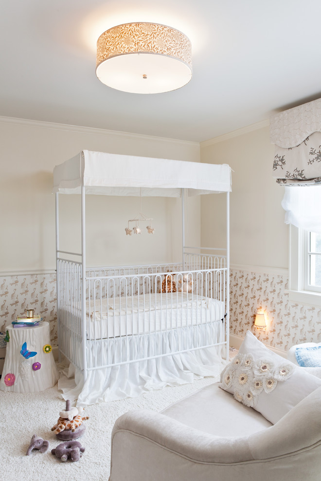 This is an example of a traditional nursery for girls in New York with beige walls and carpet.