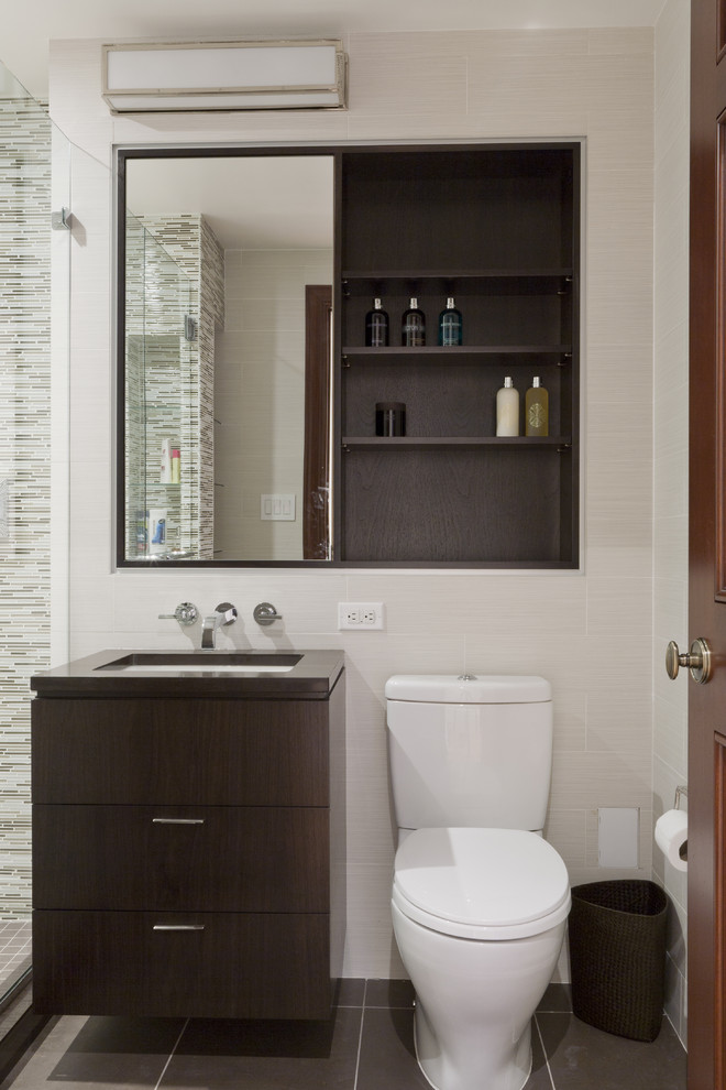 Design ideas for a contemporary bathroom in New York with flat-panel cabinets, dark wood cabinets, matchstick tile and beige tile.