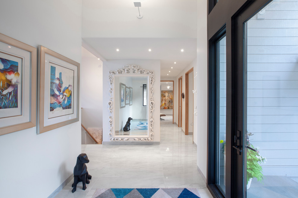 Inspiration for a mid-sized contemporary foyer in Indianapolis with white walls, porcelain floors, a single front door, a black front door and white floor.