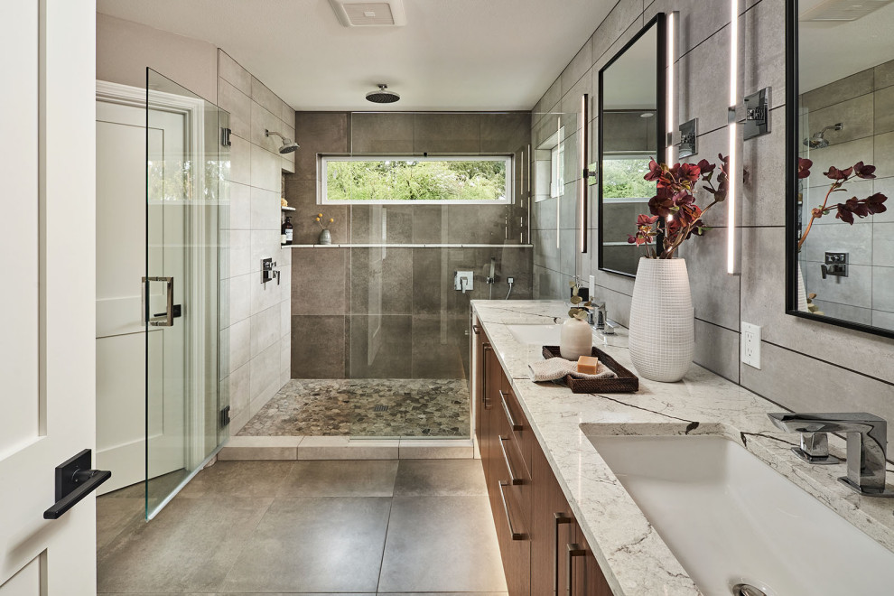 Inspiration for a mid-sized contemporary master bathroom in Portland with flat-panel cabinets, dark wood cabinets, an alcove shower, gray tile, porcelain tile, beige walls, porcelain floors, engineered quartz benchtops, grey floor, a hinged shower door, beige benchtops, a shower seat, a double vanity and a floating vanity.