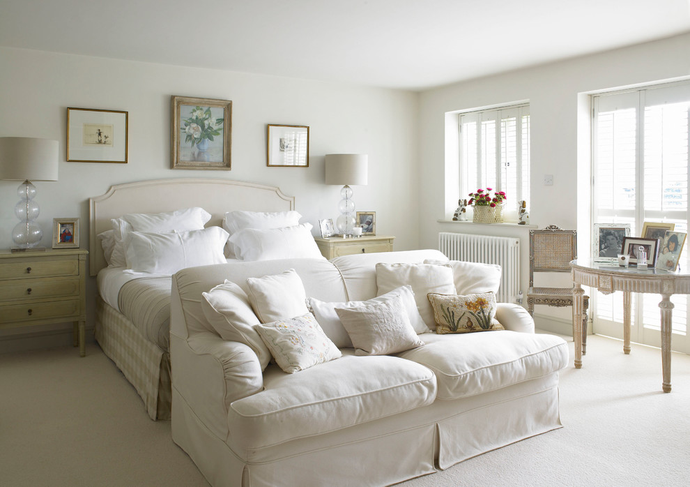 Design ideas for a large country master bedroom in Wiltshire with white walls, carpet and no fireplace.