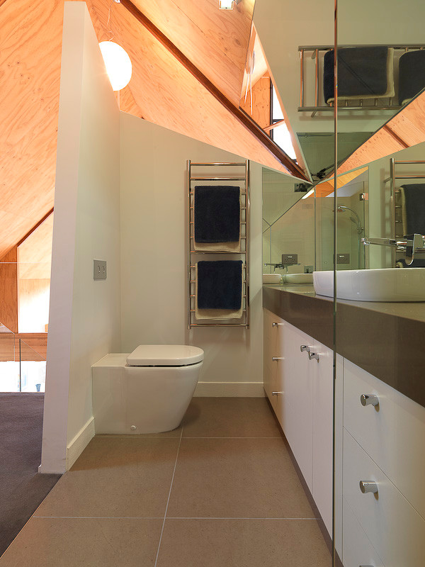 Small modern master bathroom in Melbourne with a vessel sink, flat-panel cabinets, white cabinets, engineered quartz benchtops, an alcove shower, a wall-mount toilet, beige tile, porcelain tile, white walls and porcelain floors.