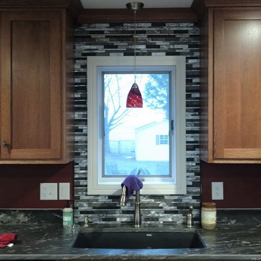 Inspiration for a large transitional u-shaped home design remodel with recessed-panel cabinets, medium tone wood cabinets, granite countertops, multicolored backsplash, an island and multicolored countertops