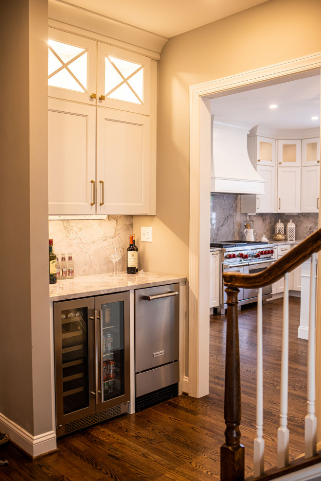 Large transitional dark wood floor and brown floor eat-in kitchen photo in Baltimore with an undermount sink, shaker cabinets, white cabinets, marble countertops, white backsplash, marble backsplash, stainless steel appliances, an island and gray countertops