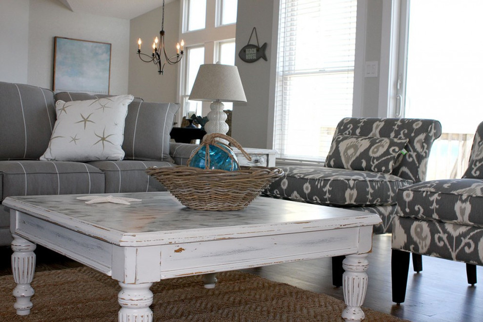 This is an example of a small beach style open concept family room in Other with grey walls and medium hardwood floors.