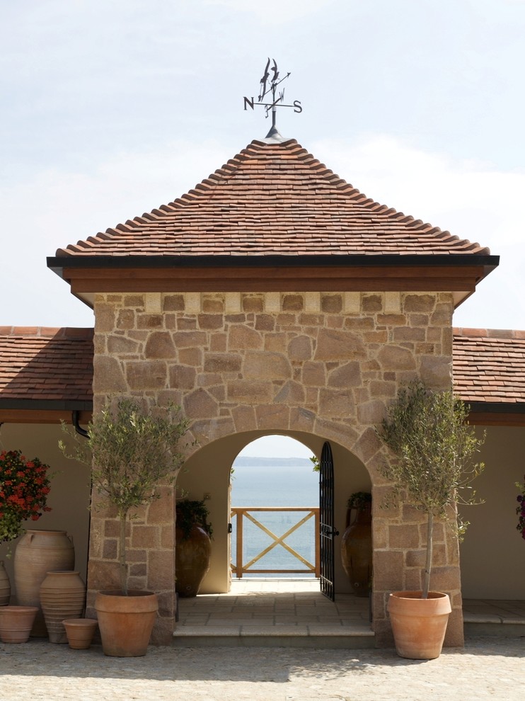 Inspiration for a traditional exterior in Channel Islands with stone veneer.
