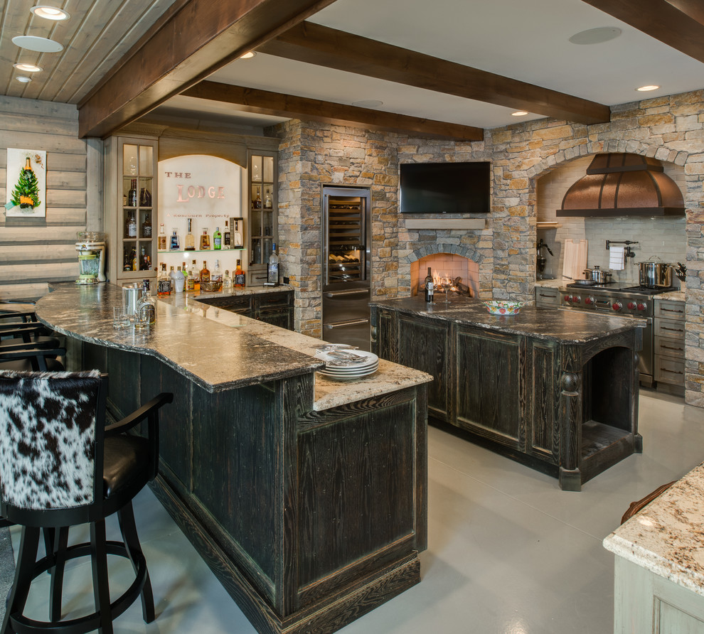 Mountain style u-shaped concrete floor eat-in kitchen photo with a farmhouse sink, distressed cabinets, granite countertops, stainless steel appliances, white backsplash, brick backsplash and an island