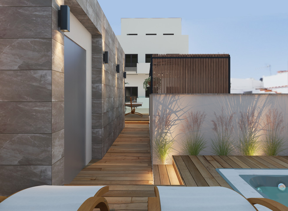 Réalisation d'une terrasse sur le toit minimaliste avec une cuisine d'été, une pergola et un garde-corps en verre.