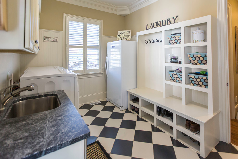Mid-sized transitional galley utility room in Raleigh with an undermount sink, open cabinets, white cabinets, soapstone benchtops, beige walls, porcelain floors and a side-by-side washer and dryer.