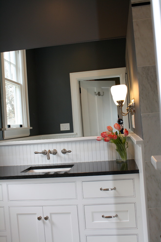 Mid-sized traditional bathroom in Charlotte with an undermount sink, beaded inset cabinets, white cabinets, an open shower, white tile, stone slab, black walls and marble floors.