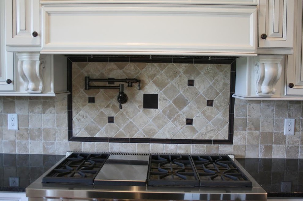 Inspiration for a large transitional kitchen remodel with white cabinets, stainless steel appliances, raised-panel cabinets, solid surface countertops, beige backsplash and ceramic backsplash