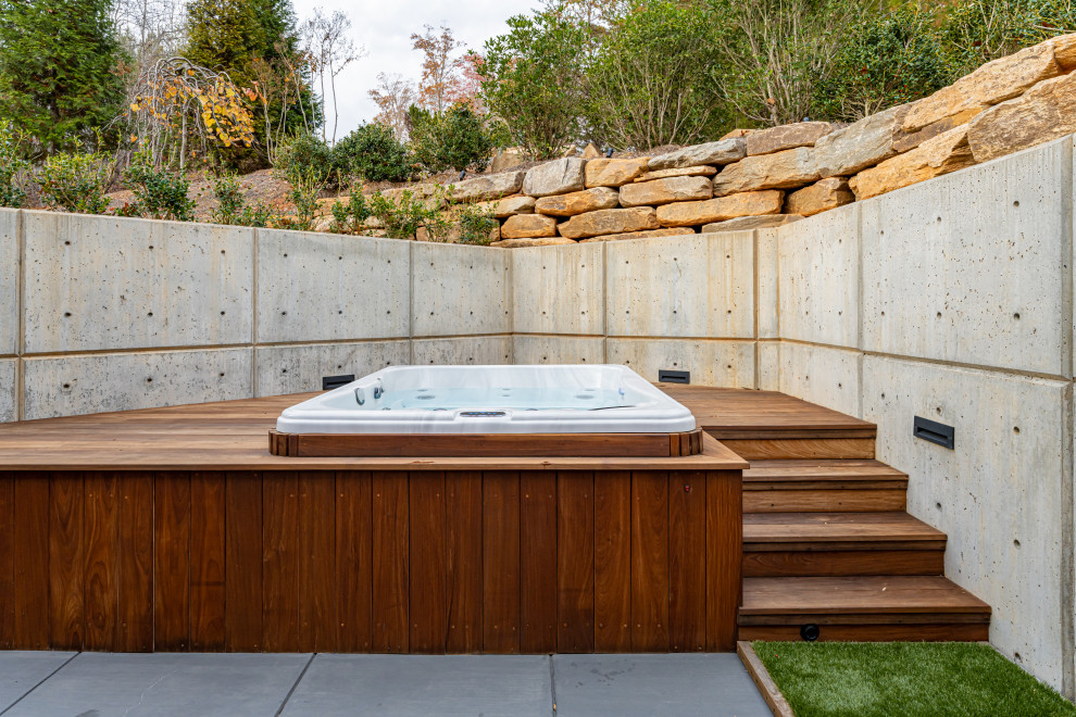Inspiration for a small contemporary backyard pool in Other with stamped concrete.