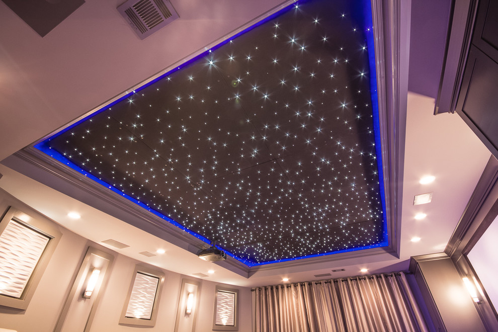 Inspiration for a large contemporary enclosed home theatre in Atlanta with beige walls, carpet, a projector screen and grey floor.