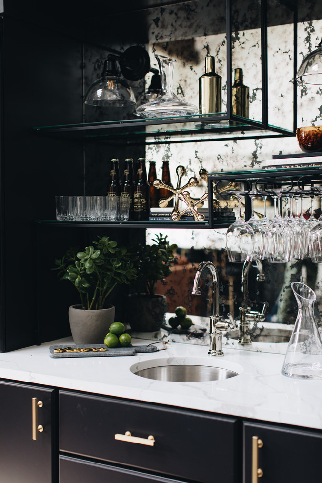 Design ideas for a mid-sized transitional single-wall home bar in Chicago with flat-panel cabinets, black cabinets, quartz benchtops, multi-coloured splashback, mirror splashback, medium hardwood floors, brown floor and white benchtop.