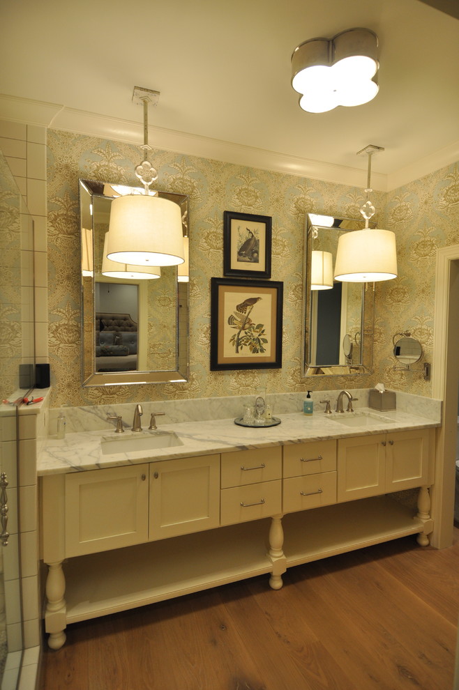 Photo of a mid-sized traditional master bathroom in Raleigh with furniture-like cabinets, beige cabinets, medium hardwood floors, an undermount sink, marble benchtops and a hinged shower door.