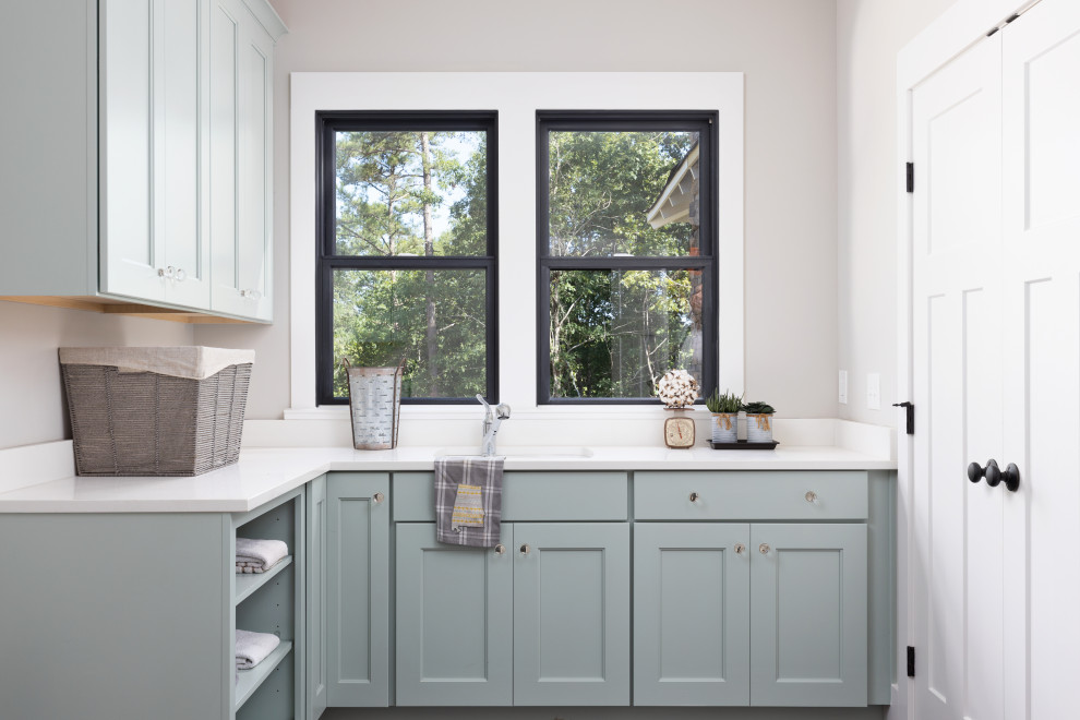 Inspiration for a country l-shaped laundry room in Birmingham with an undermount sink, beaded inset cabinets, grey cabinets, grey walls and white benchtop.