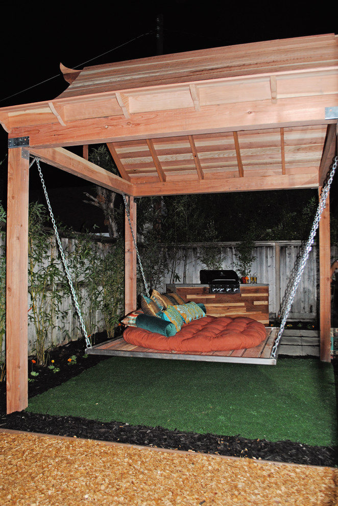 Photo of a mid-sized asian backyard patio in Sacramento with a fire feature, concrete pavers and a pergola.
