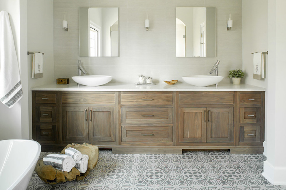 Design ideas for a beach style master bathroom in Los Angeles with shaker cabinets, medium wood cabinets, grey walls, a vessel sink, multi-coloured floor and white benchtops.