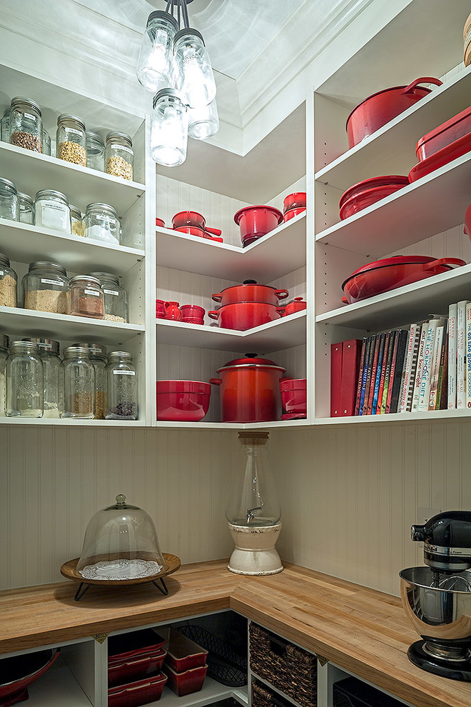 Example of a mid-sized transitional l-shaped kitchen pantry design in Toronto with white cabinets, quartz countertops and an island