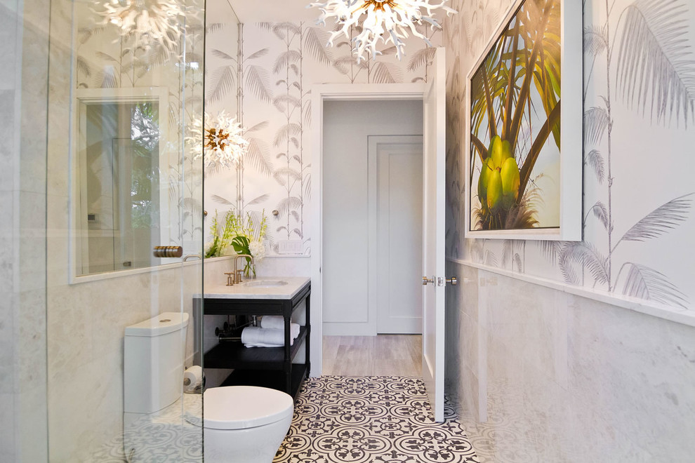 Example of a transitional 3/4 cement tile floor and multicolored floor corner shower design in Miami with open cabinets, black cabinets, a two-piece toilet, white walls and an undermount sink