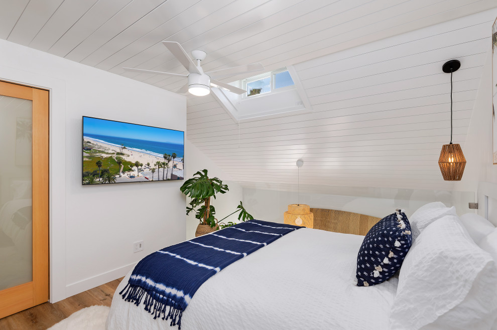 Bedroom - small coastal loft-style bedroom idea in Santa Barbara with white walls