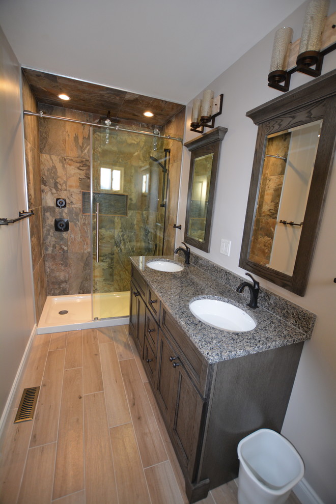Alcove shower - mid-sized transitional 3/4 multicolored tile and porcelain tile porcelain tile alcove shower idea in Toronto with shaker cabinets, distressed cabinets, a one-piece toilet, gray walls, an undermount sink and granite countertops