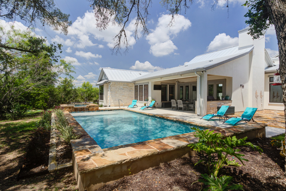Inspiration for a mid-sized transitional backyard rectangular natural hot tub remodel in Austin with decking