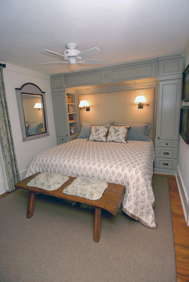 This is an example of a small beach style guest bedroom in Orlando with blue walls and medium hardwood floors.