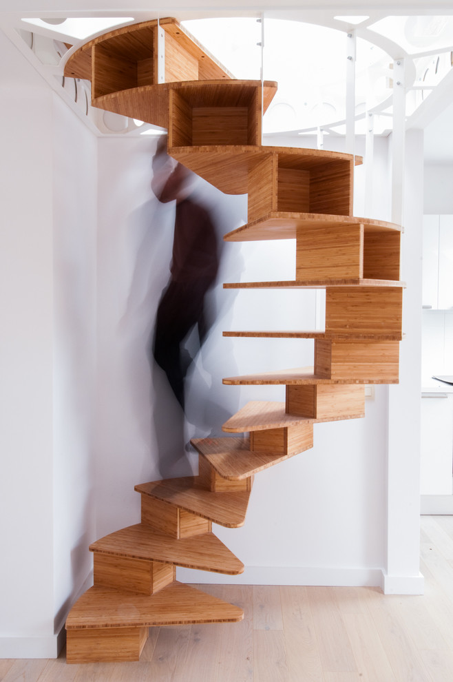 Design ideas for a contemporary wood spiral staircase in Paris with wood risers.