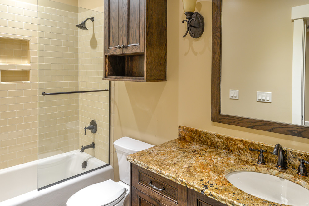 Arts and crafts kids bathroom in Other with an undermount sink, beaded inset cabinets, medium wood cabinets, granite benchtops, a drop-in tub, an open shower, stone tile and concrete floors.