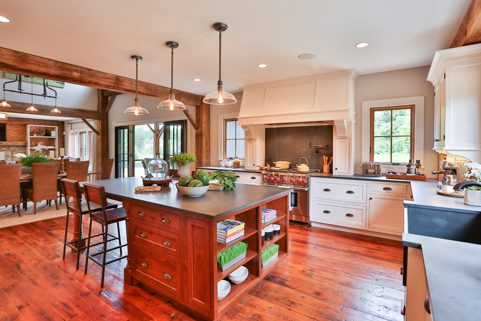 This is an example of a large country u-shaped separate kitchen in Boston with a farmhouse sink, shaker cabinets, white cabinets, solid surface benchtops, light hardwood floors and with island.