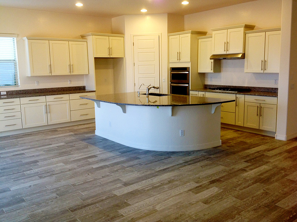 Open concept kitchen - huge transitional l-shaped porcelain tile open concept kitchen idea in Phoenix with an undermount sink, recessed-panel cabinets, white cabinets, granite countertops, stainless steel appliances and an island