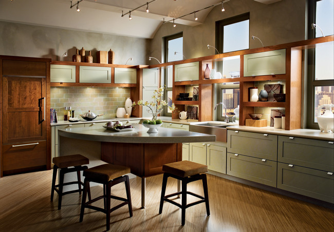Inspiration for an expansive traditional l-shaped eat-in kitchen in Denver with a farmhouse sink, shaker cabinets, green cabinets, quartz benchtops, green splashback, glass tile splashback, panelled appliances, light hardwood floors and with island.