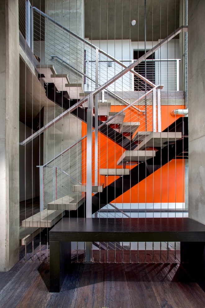 Contemporary concrete staircase in Vancouver with open risers.