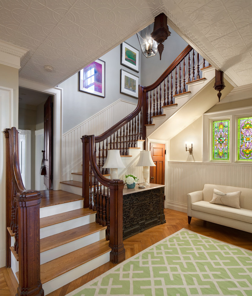 Photo of a traditional wood staircase in Providence with painted wood risers.
