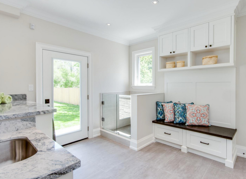 Design ideas for a large traditional single-wall dedicated laundry room in Toronto with an undermount sink, recessed-panel cabinets, white cabinets, granite benchtops, white walls, a side-by-side washer and dryer, ceramic floors and beige floor.