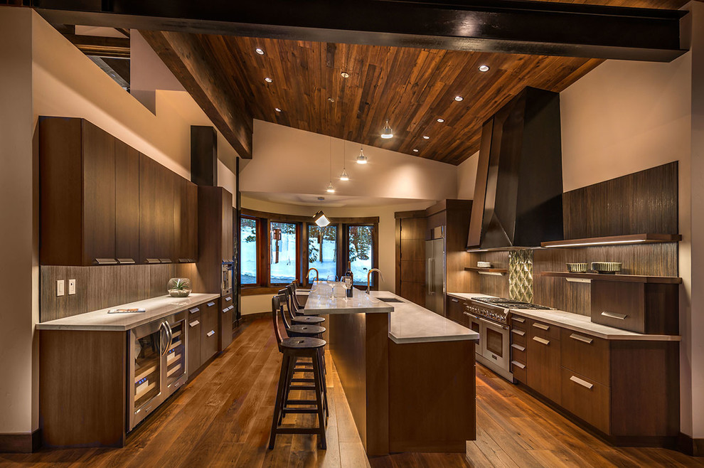 Inspiration for a large country galley kitchen in Other with an undermount sink, flat-panel cabinets, dark wood cabinets, stainless steel appliances, dark hardwood floors, with island, quartz benchtops and brown splashback.