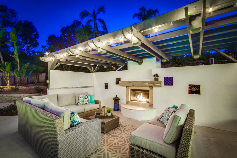 Photo of a mediterranean patio in San Diego with a gazebo/cabana and with fireplace.