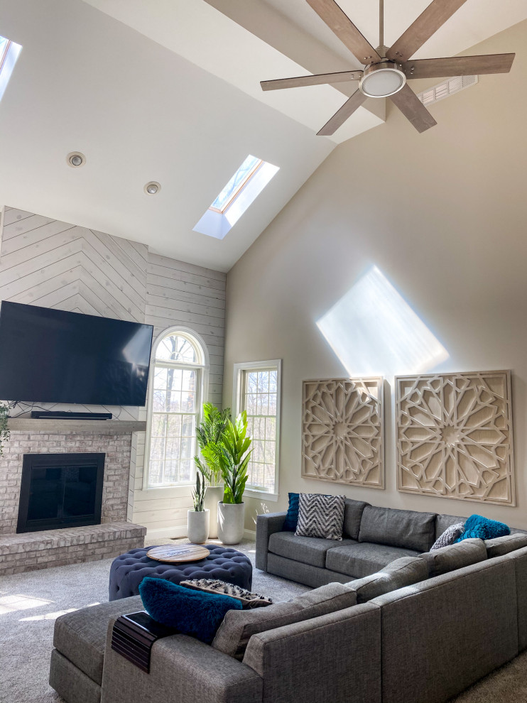 Living room - large country open concept carpeted, beige floor, vaulted ceiling and shiplap wall living room idea in New York with beige walls, a standard fireplace, a brick fireplace and a wall-mounted tv